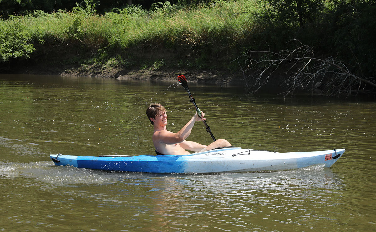 Young man kayaking Baraboo River at Haskins Park by Rhonda Siebecker cropped Kelsey McDermott